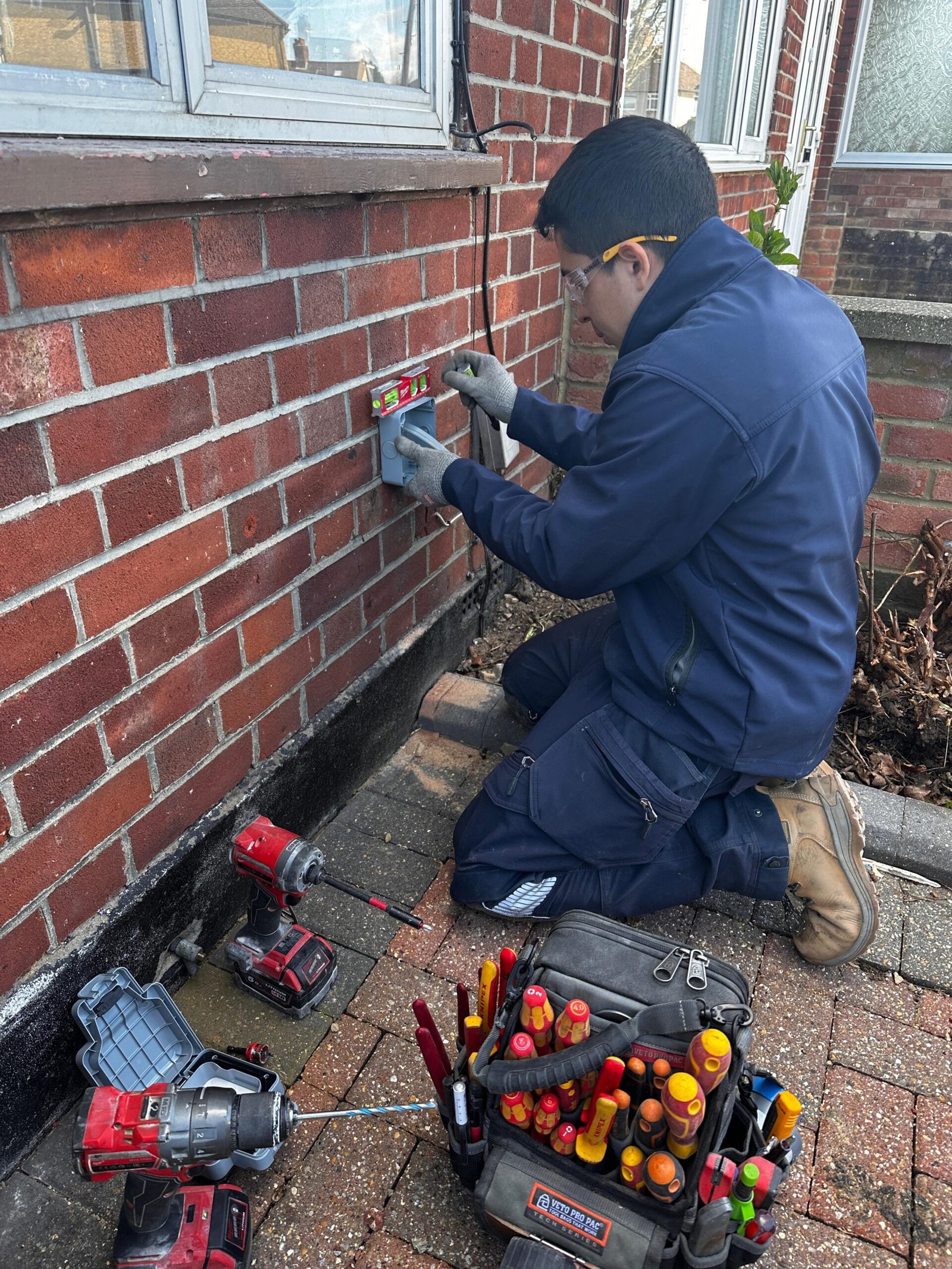 Cruz Electrical electrician installing outdoor socket, North West London