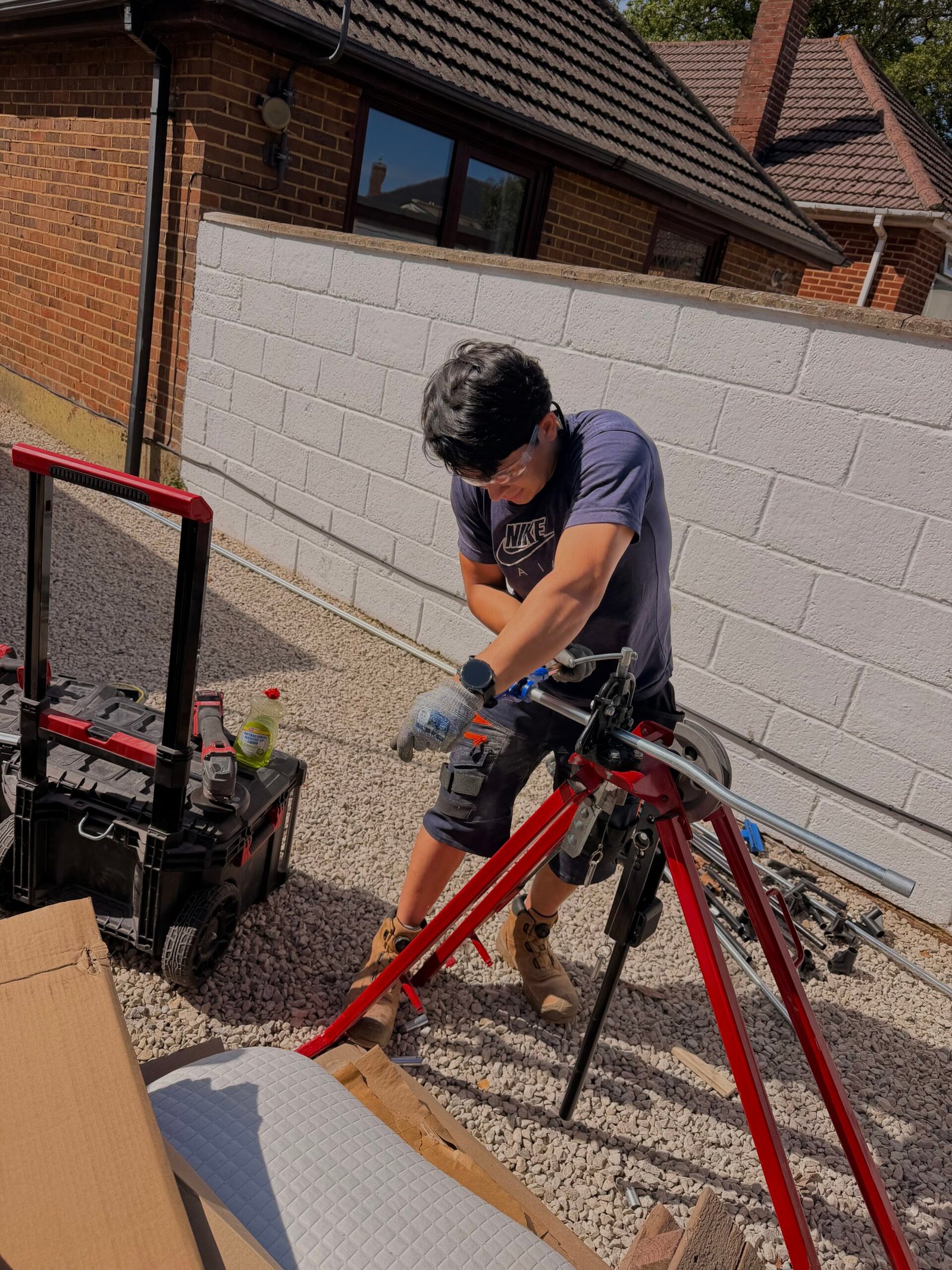 Cruz Electrical electrician bending metal conduit on site in North West London